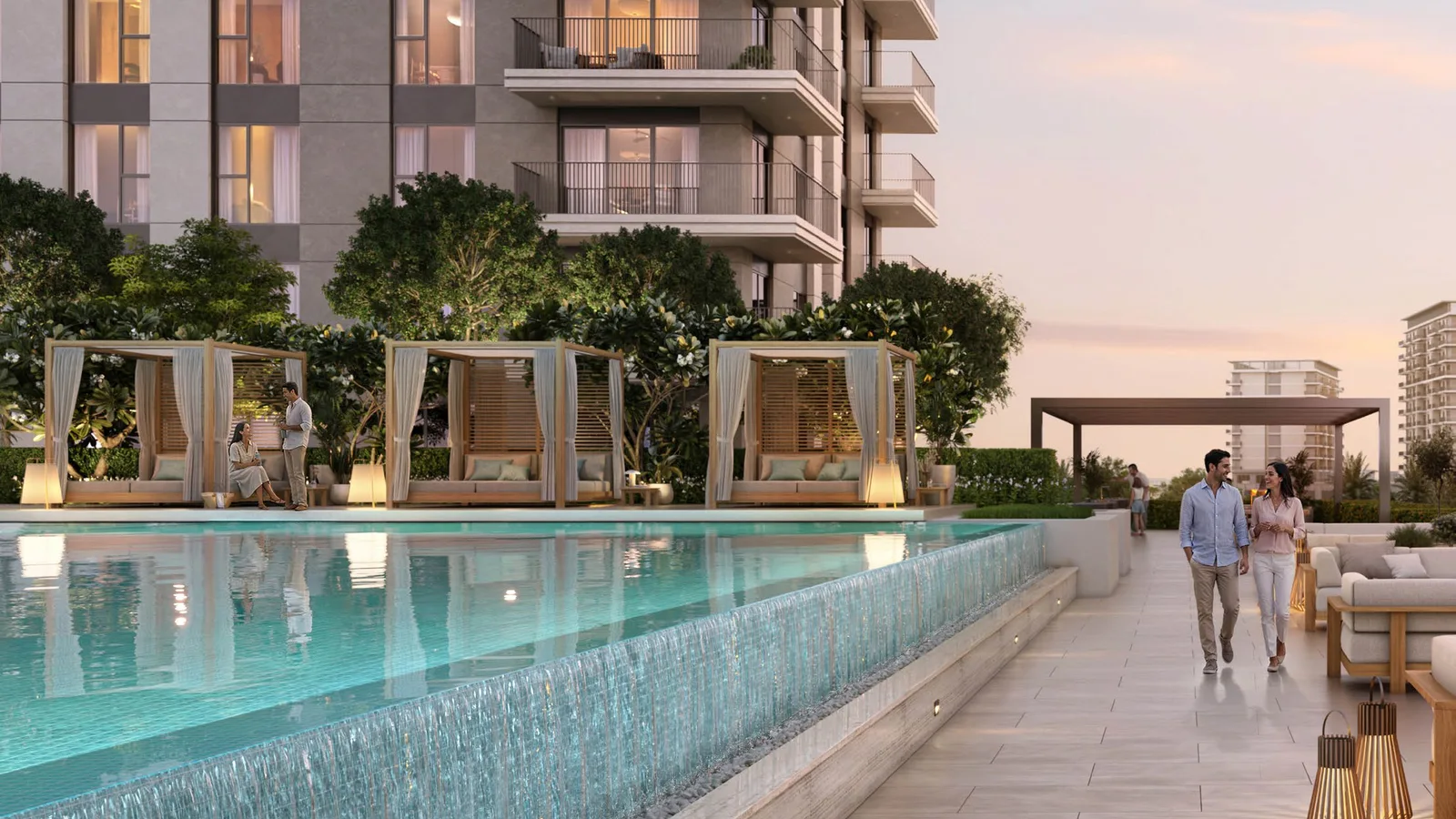 Infinity pool with cabanas alongside the Golf Fields building at dusk