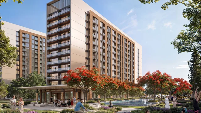 Exterior view of The Woods residential tower at Sobha Sanctuary, with landscaped plaza and flame trees