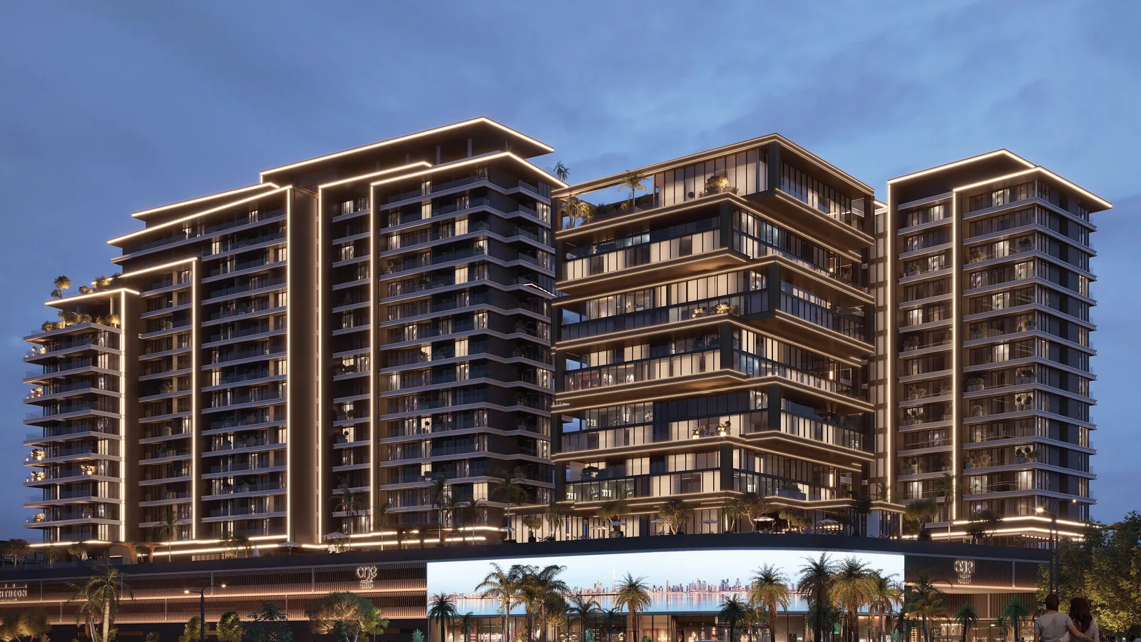One RAK Central – Phase II illuminated tower exterior with retail podium at dusk in RAK Central, Ras Al Khaimah