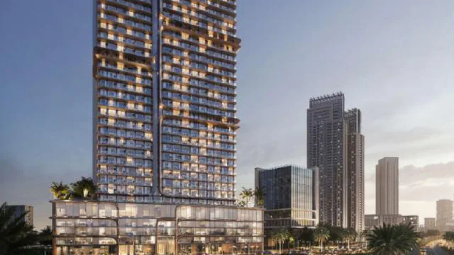 VOXA Residences & Offices illuminated tower exterior at dusk in Jumeirah Village Triangle, Dubai