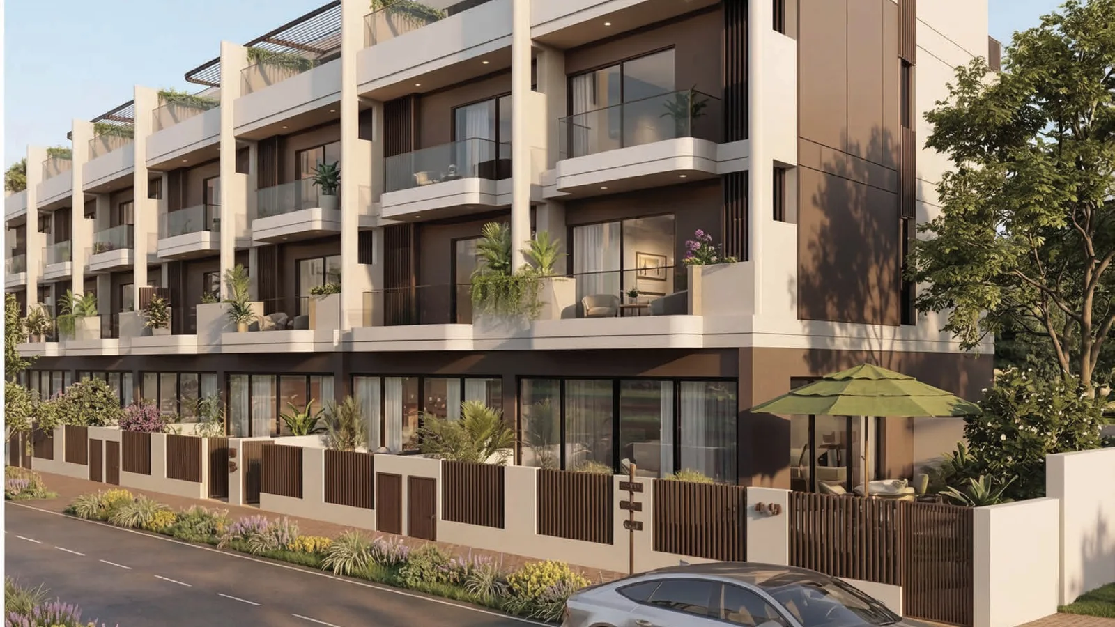 Street view of the Sol Terra Casa townhouses with landscaped frontage in Jumeirah Village Circle, Dubai