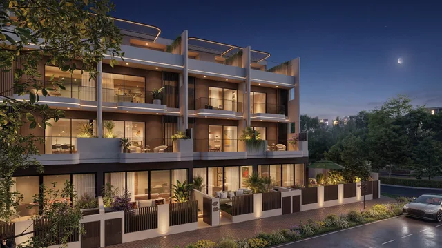 Sol Terra Casa luxury townhouses illuminated at dusk, showing the three-storey facades and terraces