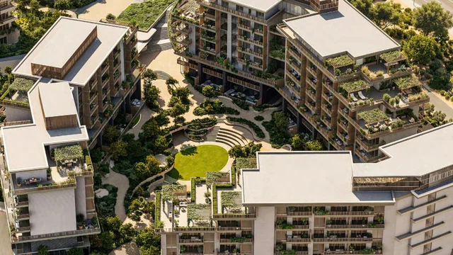 Aerial view of Arancia Yards' three low-rise buildings around landscaped courtyards in City of Arabia, Dubai