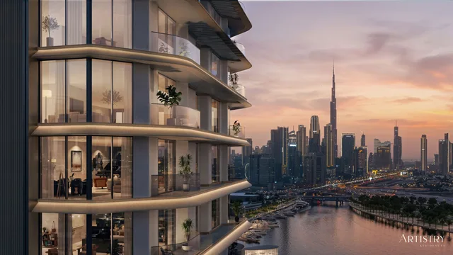 Artistry Two Residences tower exterior with curved glass balconies and the Burj Khalifa skyline at sunset
