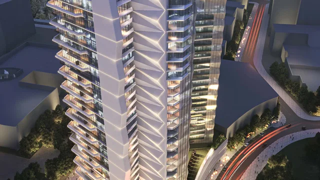 Aerial view of Élevé by Deyaar at dusk, its sculpted tower rising above Downtown Jebel Ali