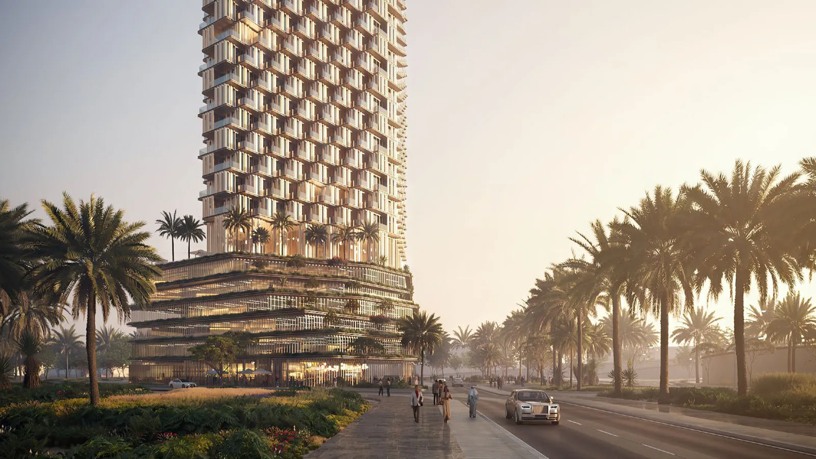 Street-level view of One B Tower with its terraced, faceted facade and palm-lined boulevard