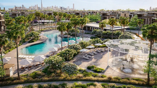 The resort-style community pool and lagoon with the Dubai skyline beyond at Nad Al Sheba Gardens Phase 11 by Meraas