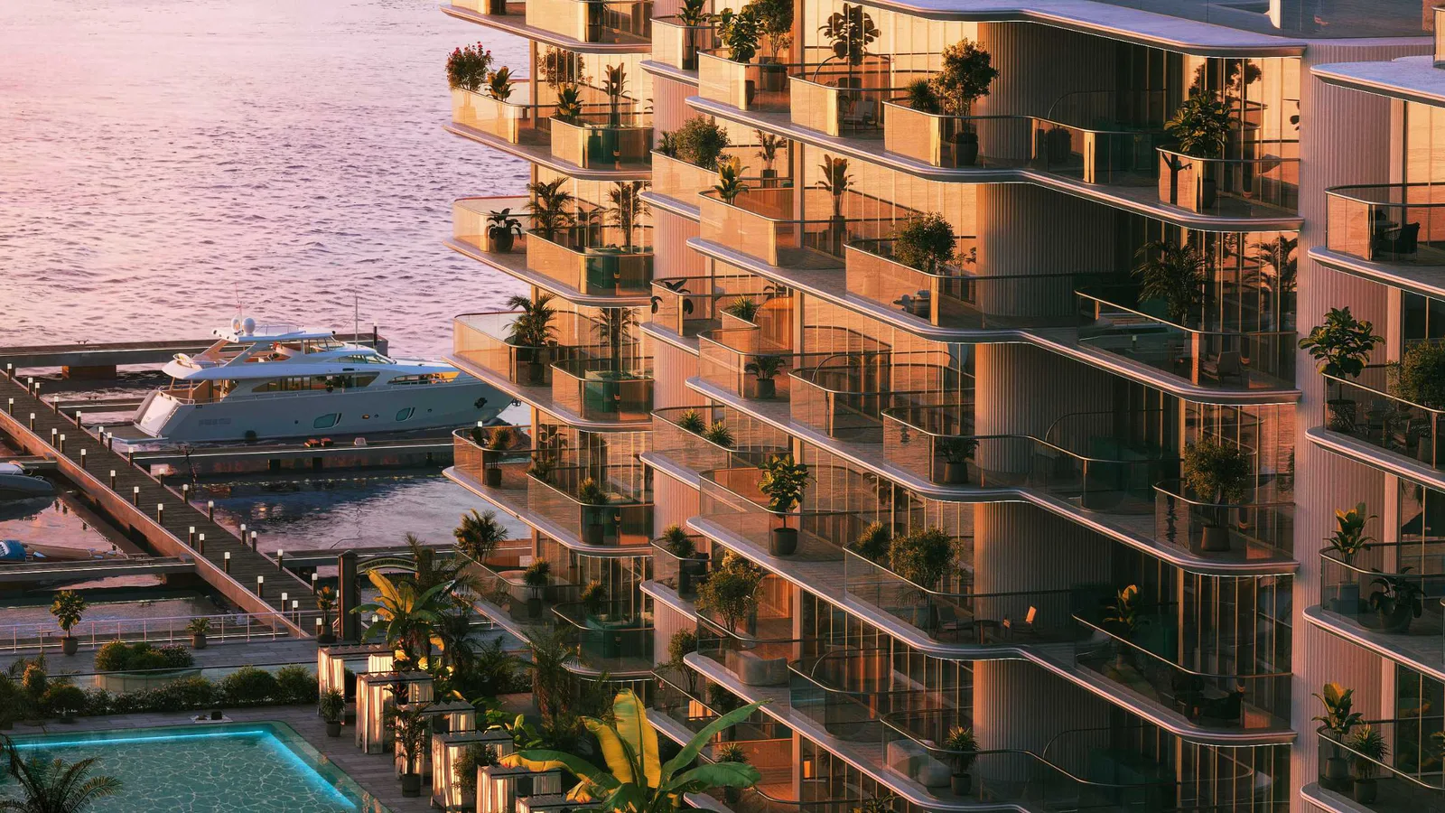Planted balconies and terraces of Le Château Piétrus overlooking the Dubai Islands marina and moored yachts at sunset