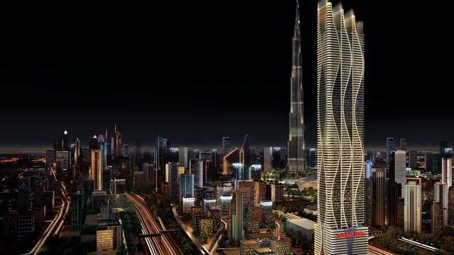 Bayz 101 tower illuminated above the Business Bay skyline at night
