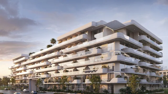 Street-level exterior of Oxford Cove by Iman with curved balconies and landscaped frontage