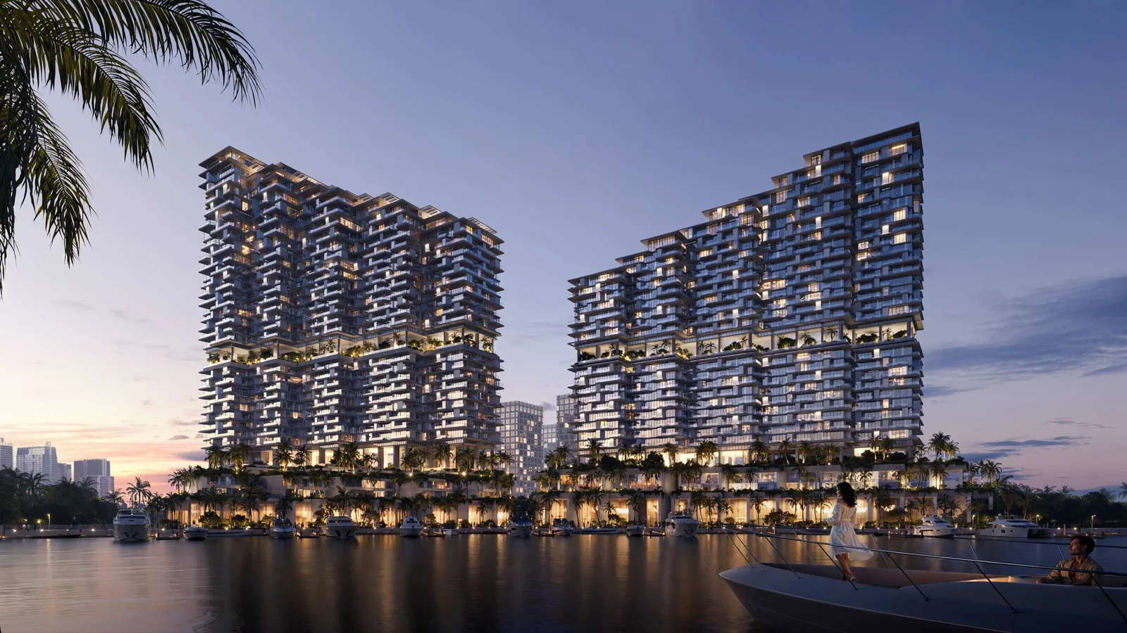 Riviera Residences waterfront exterior illuminated at dusk