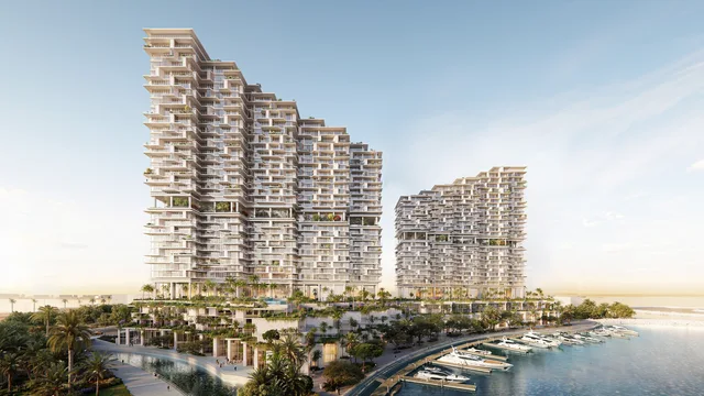 Daytime waterfront exterior of Riviera Residences beside the marina