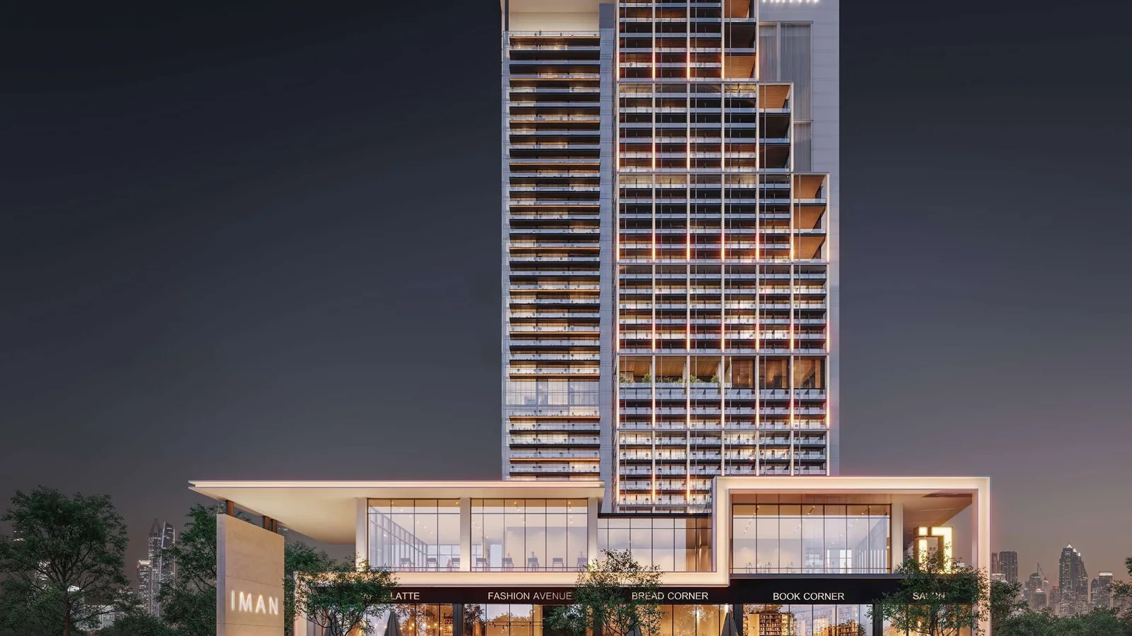 Sierra by Iman tower and ground-floor retail illuminated at night