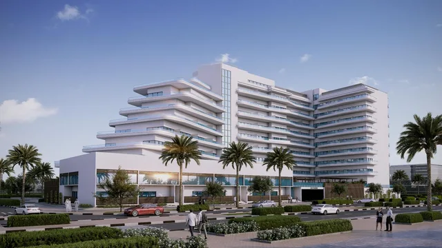 Street-facing exterior of Mayyas at The Bay with curved balconies and landscaped frontage
