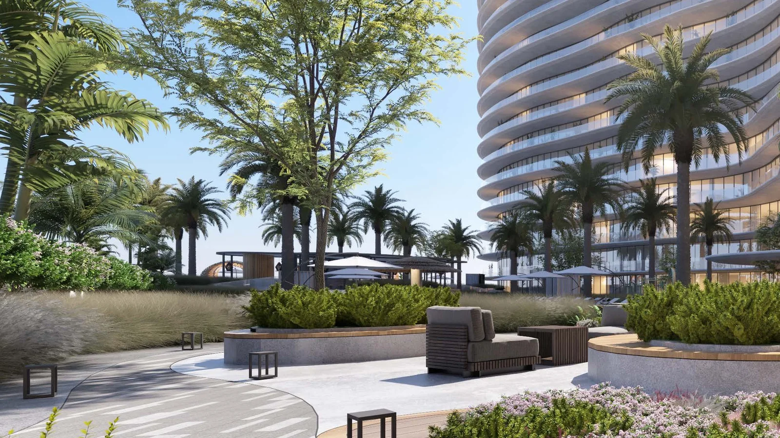 Landscaped promenade and shaded seating between The Beach Residences buildings