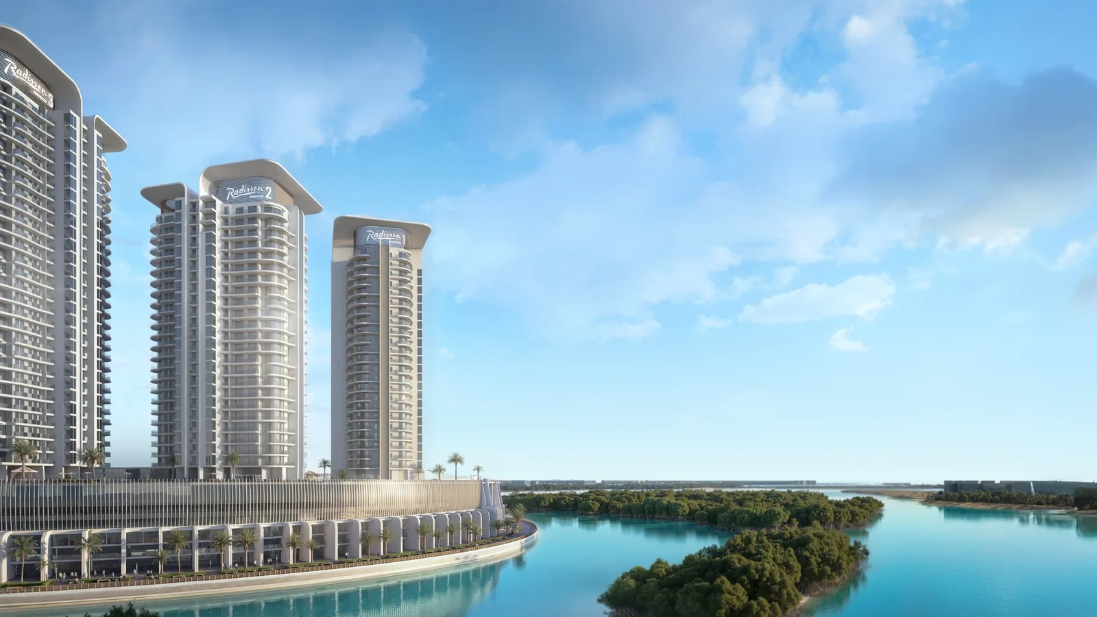 Panoramic waterfront exterior of the three Radisson Residences towers