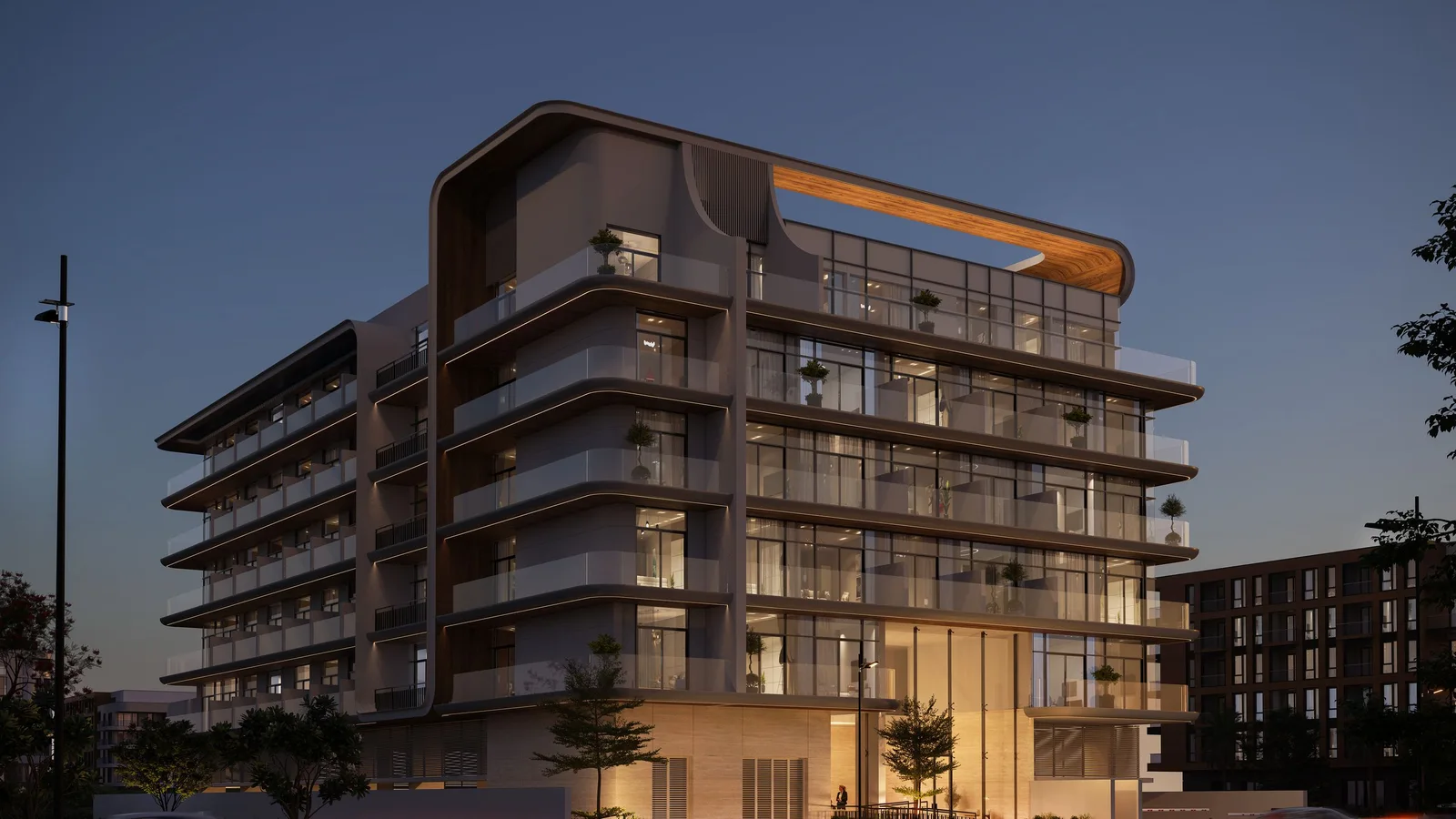 Evening exterior of Chapter 02 with illuminated balconies