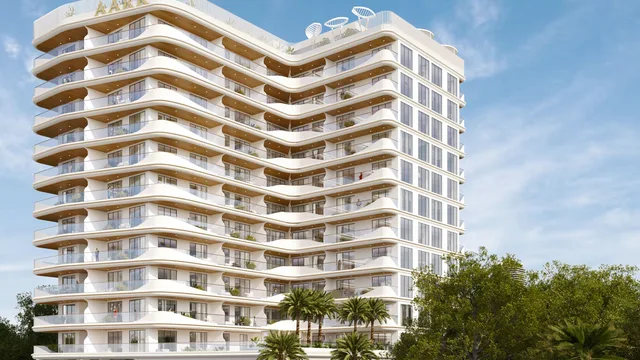 Aark Terraces tower exterior with illuminated balconies and landscaped frontage