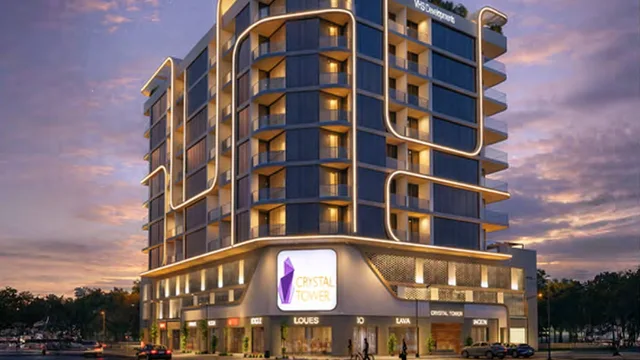 Crystal Tower exterior with curved balconies and illuminated ground-floor frontage.