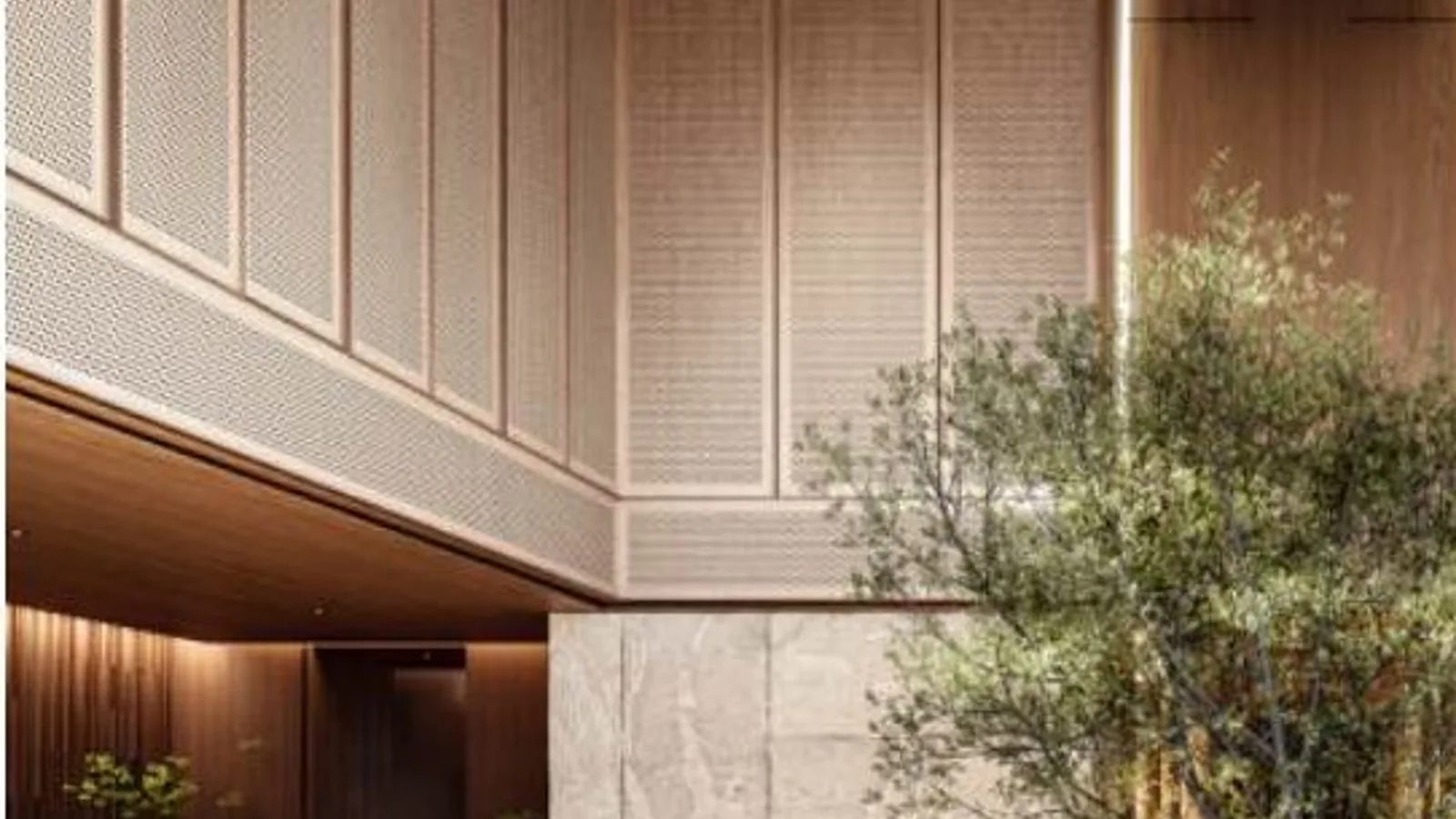 Double-height lobby with indoor tree and seating at Mas Barsha Residency