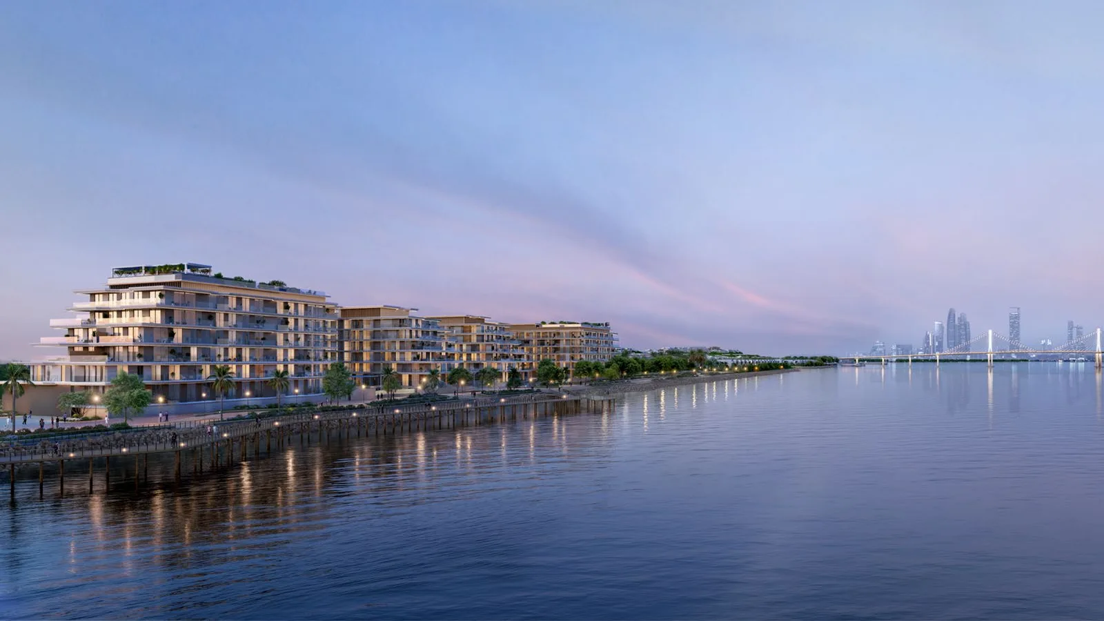 Residence buildings and waterfront promenade at dusk at Bashayer Residences.