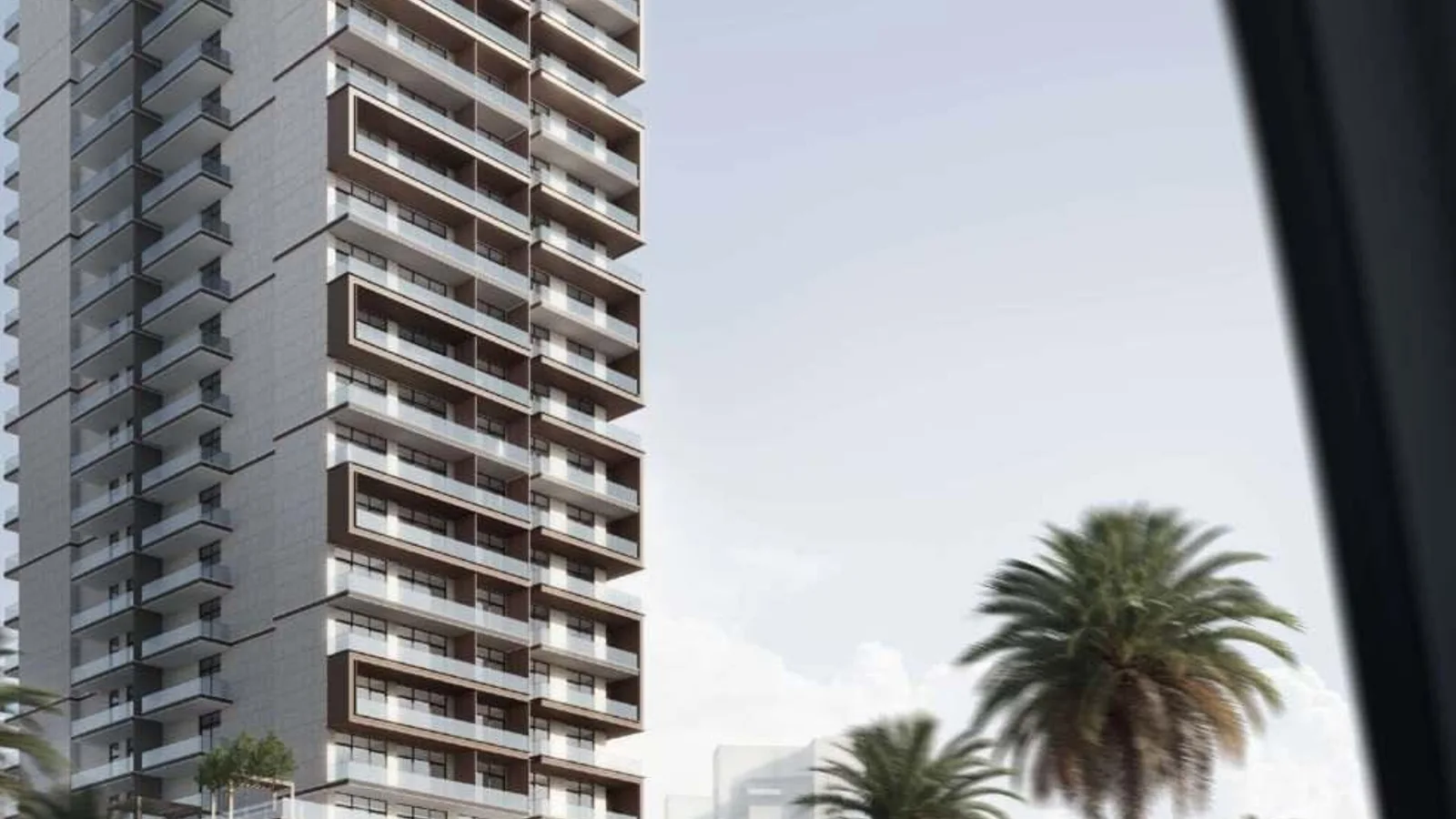 Exterior view of W1NNER Tower showing the residential tower rising above its parking podium.
